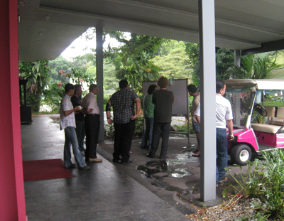 Researchers gather at outdoor whiteboard to collaborate during quantum discord workshop.